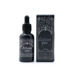 Frasco negro mate de aceite de perfume Athame Noir de 30 ml con cuentagotas junto a su caja ilustrada