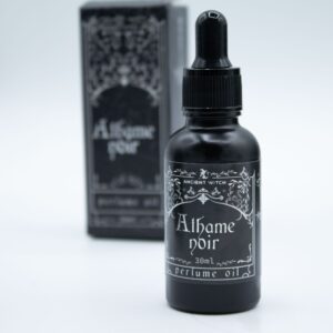 Frasco negro mate de aceite de perfume Athame Noir de 30 ml con cuentagotas junto a su caja ilustrada
