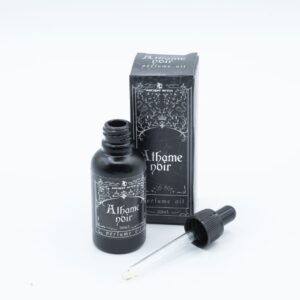 Frasco negro mate de aceite de perfume Athame Noir de 30 ml con cuentagotas junto a su caja ilustrada