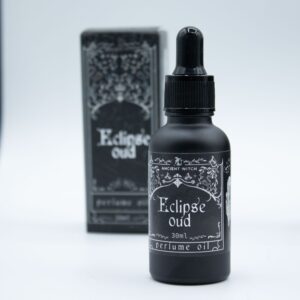 Frasco negro mate de aceite de perfume Eclipse Oud de 30 ml con cuentagotas y su caja negra ilustrada