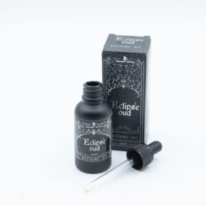 Frasco negro mate de aceite de perfume Eclipse Oud de 30 ml con cuentagotas y su caja negra ilustrada