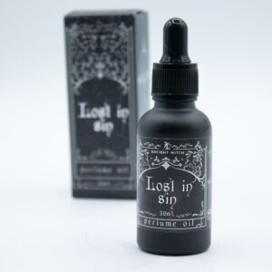 Frasco negro mate de aceite de perfume Perdido en el pecado de 30 ml con cuentagotas junto a su caja