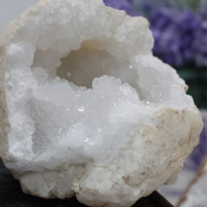 Mitad de una geoda de calcita con el interior de cristales blancos y grises