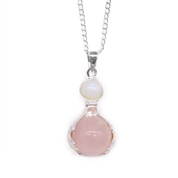 Colgante de dos manos con baño de plata que sostienen una esfera de cuarzo rosa, con cabujón blanco y cadena