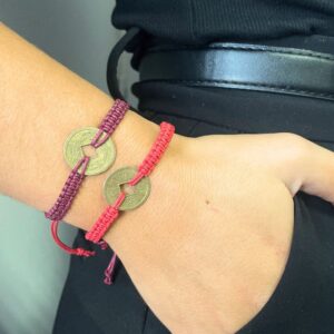 Tres pulseras de la amistad trenzadas en rojo, azul y amarillo con moneda china en el centro; se envía una, de color al azar