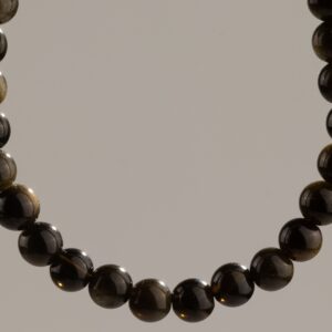 Pulsera elástica fina de cuentas de obsidiana dorada, negras con reflejo dorado