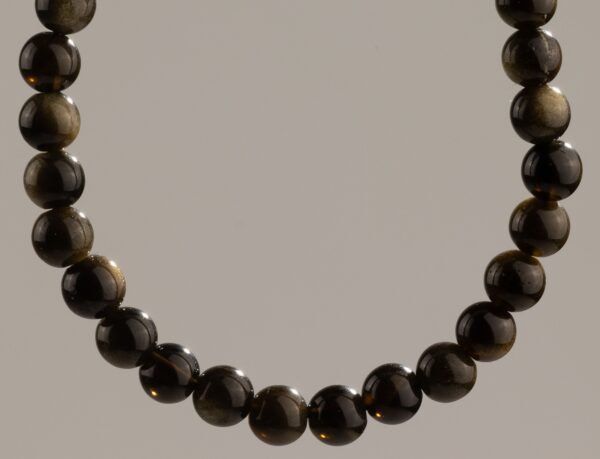 Pulsera elástica fina de cuentas de obsidiana dorada, negras con reflejo dorado