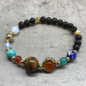 Pulsera de cuentas de lava negra con planetas de colores, Saturno con aro dorado y estrellas doradas