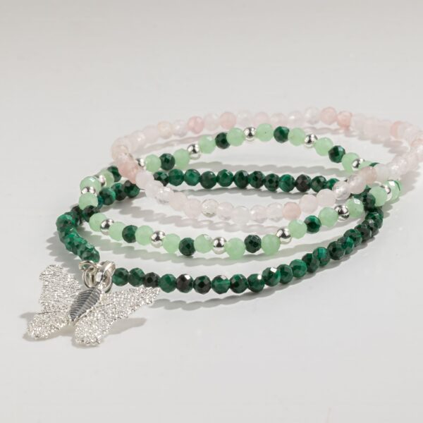Tres pulseras elásticas de malaquita verde oscuro, aventurina verde claro y cuarzo rosa, una con colgante de mariposa de tono plateado