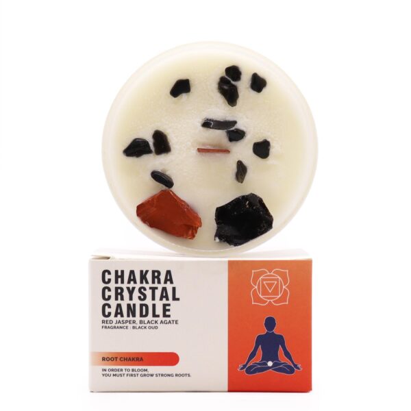 Vela del chakra raíz en vaso blanco con jaspe rojo y ágata negra sobre la cera, apoyada en su caja roja ilustrada