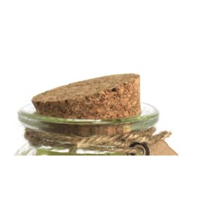 Vela de soja de color verde lima en tarro de cristal estriado con etiqueta kraft que dice Vanilla